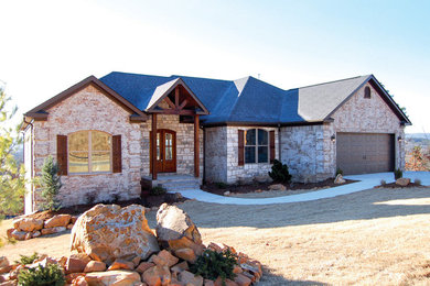 Example of a mid-sized mountain style one-story mixed siding exterior home design in Little Rock with a shingle roof