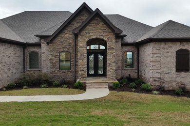 Example of an exterior home design in Little Rock with a hip roof