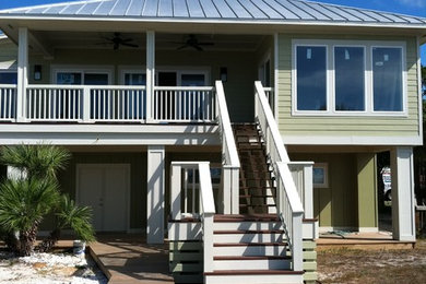 Example of a mid-sized trendy green two-story wood exterior home design in Tampa