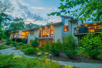 Example of a trendy two-story mixed siding exterior home design in Providence with a metal roof