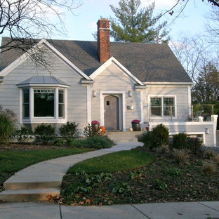 Example of a mid-sized classic gray one-story concrete fiberboard gable roof design in Detroit