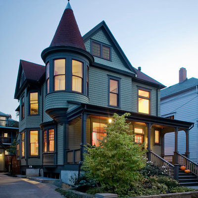 Ornate green exterior home photo in Portland