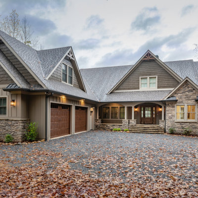 Large mountain style brown two-story concrete fiberboard exterior home photo in Atlanta with a mixed material roof