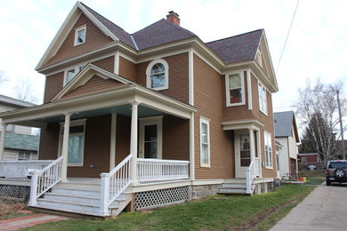 Photo of a large and brown classic two floor house exterior in Grand Rapids with wood cladding.