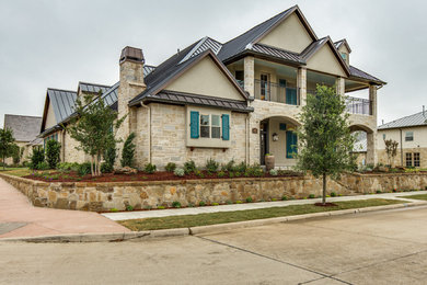 Large traditional beige two-story stone house exterior idea in Dallas with a shed roof
