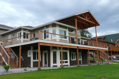 Example of a trendy split-level concrete fiberboard gable roof design in Seattle