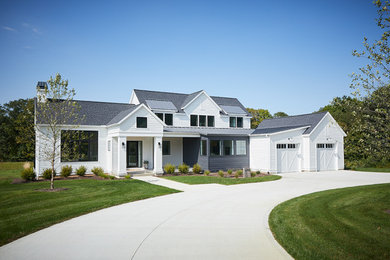 White two-story concrete fiberboard house exterior idea in Grand Rapids with a mixed material roof