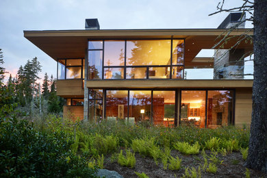 Inspiration for a mid-sized contemporary brown two-story wood house exterior remodel in Other