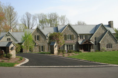 Inspiration for a huge timeless brown two-story stone exterior home remodel in Philadelphia with a shingle roof