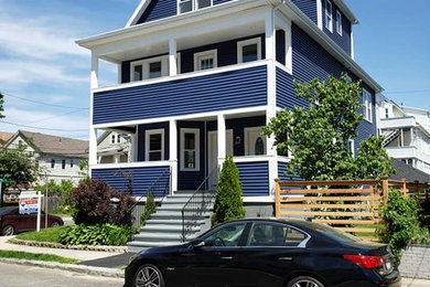Mid-sized trendy blue three-story vinyl exterior home photo in Boston with a shingle roof