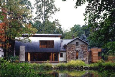 This is an example of a medium sized farmhouse two floor house exterior in Philadelphia with mixed cladding.