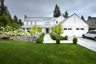 Mid-sized farmhouse white two-story wood exterior home photo in Seattle with a metal roof