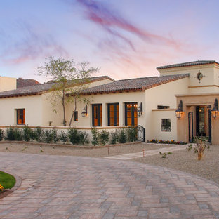 Large tuscan two-story stucco exterior home photo in Phoenix