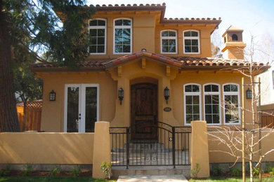 Example of a mid-sized tuscan beige two-story stucco exterior home design in San Francisco