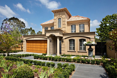 Example of a large trendy beige two-story house exterior design in Melbourne