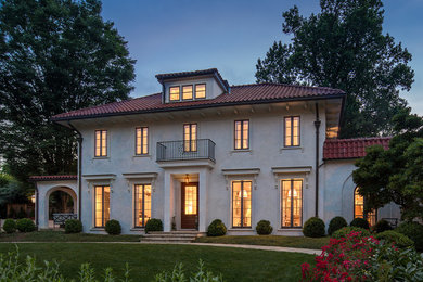 Large mediterranean beige three-story stucco exterior home idea in DC Metro with a hip roof