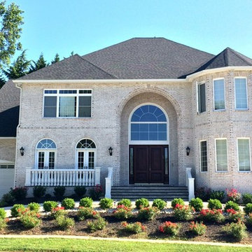 Mediterranean Style Custom Home With White Brick & Arched Front Enterance