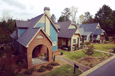 Example of a mid-sized arts and crafts blue two-story mixed siding gable roof design in Other