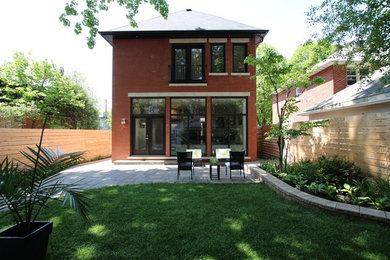 Mid-sized transitional red three-story brick house exterior photo in Ottawa with a hip roof and a tile roof
