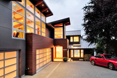 Large contemporary brown two-story mixed siding flat roof idea in Seattle