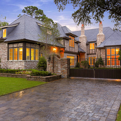 Inspiration for a mediterranean two-story brick exterior home remodel in Houston with a hip roof