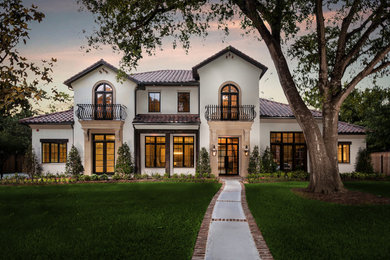 Huge mediterranean white two-story stucco gable roof idea in Houston