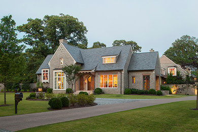 Example of a large classic gray two-story stone exterior home design in Other