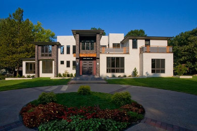 Inspiration for a large and beige contemporary two floor brick house exterior in Other.