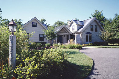 Example of a classic gray two-story gable roof design in Burlington