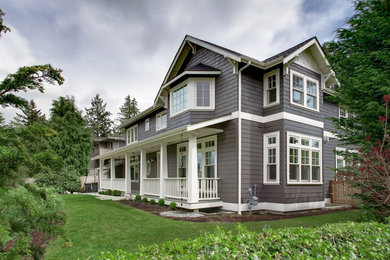 Example of a large classic gray two-story concrete fiberboard gable roof design in Seattle