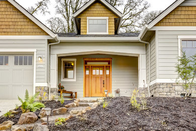 Inspiration for a large craftsman yellow two-story mixed siding exterior home remodel in Portland with a shingle roof