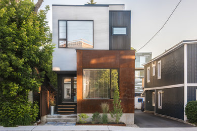 This is an example of a modern house exterior in Ottawa with metal cladding and a flat roof.