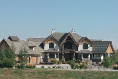 Example of a huge southwest gray three-story mixed siding exterior home design in Denver with a hip roof