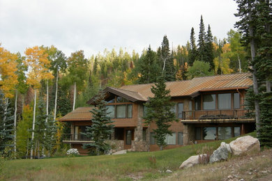 Example of a mountain style beige two-story mixed siding exterior home design in Denver with a metal roof