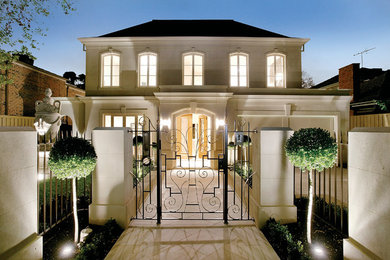 Example of a trendy beige two-story exterior home design in Melbourne