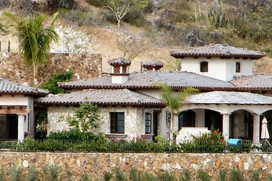 Huge tuscan beige one-story stucco exterior home photo with a hip roof
