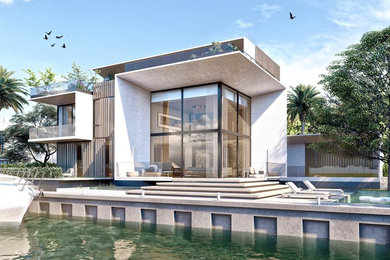 Example of a large trendy gray three-story concrete exterior home design in Miami with a mixed material roof