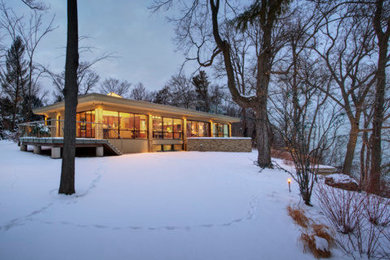 Example of a large 1950s beige two-story brick exterior home design in Chicago