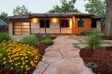 Example of a mid-sized classic beige one-story mixed siding house exterior design in Denver with a mixed material roof