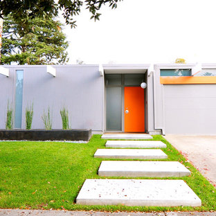 Photo of a gey midcentury one floor house exterior in San Francisco with a flat roof.