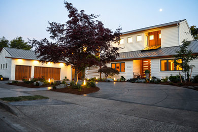 Huge 1950s white two-story wood and clapboard exterior home idea in Portland with a metal roof and a gray roof