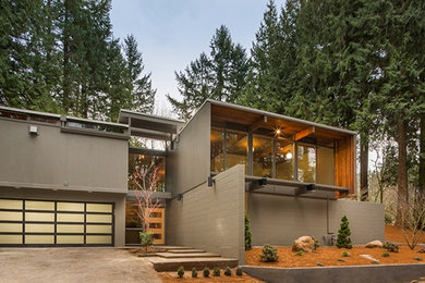Example of a mid-sized gray two-story concrete exterior home design in Portland