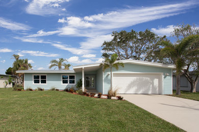 Minimalist blue one-story house exterior photo in Orlando with a metal roof