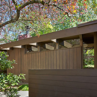 Example of a small 1960s brown two-story wood flat roof design in San Francisco