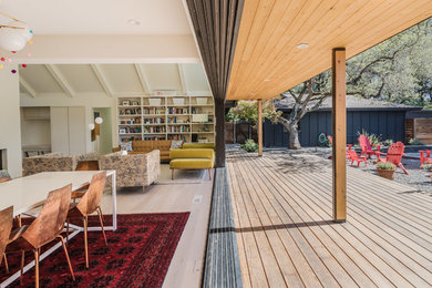 1960s black wood house exterior photo in San Francisco with a hip roof and a shingle roof