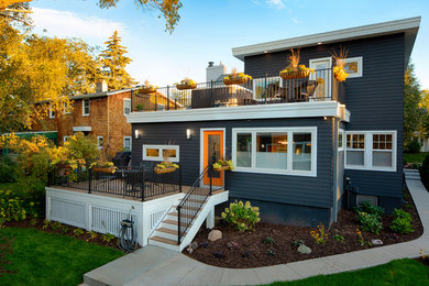 Inspiration for a mid-sized contemporary gray two-story vinyl exterior home remodel in Minneapolis with a shingle roof