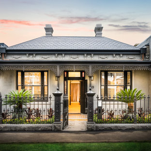 This is an example of a victorian one-storey white house exterior in Melbourne with a hip roof and a tile roof.