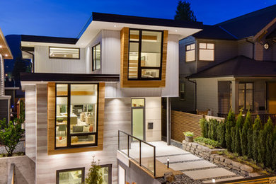 Contemporary gray three-story flat roof idea in Vancouver