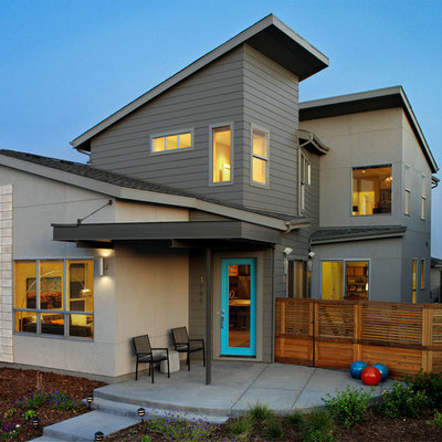 Contemporary gray two-story exterior home idea in Denver with a shed roof