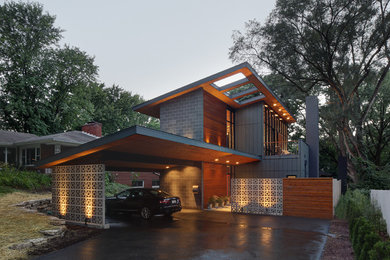Inspiration for a mid-sized contemporary gray two-story mixed siding house exterior remodel in Milwaukee with a shed roof